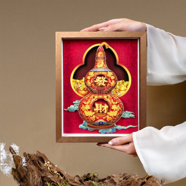 Hands presenting an intricate Chinese Paper Cutting Artwork featuring a 3D fortune gourd design