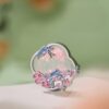 traditional Chinese art refrigerator magnet souvenir showcased against blended green and pink background