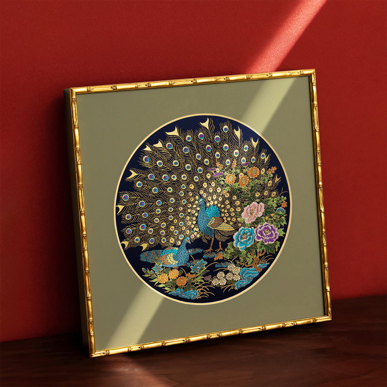 Nanjing Yunjin silk brocade peacock embroidery artwork leaning against a red wall