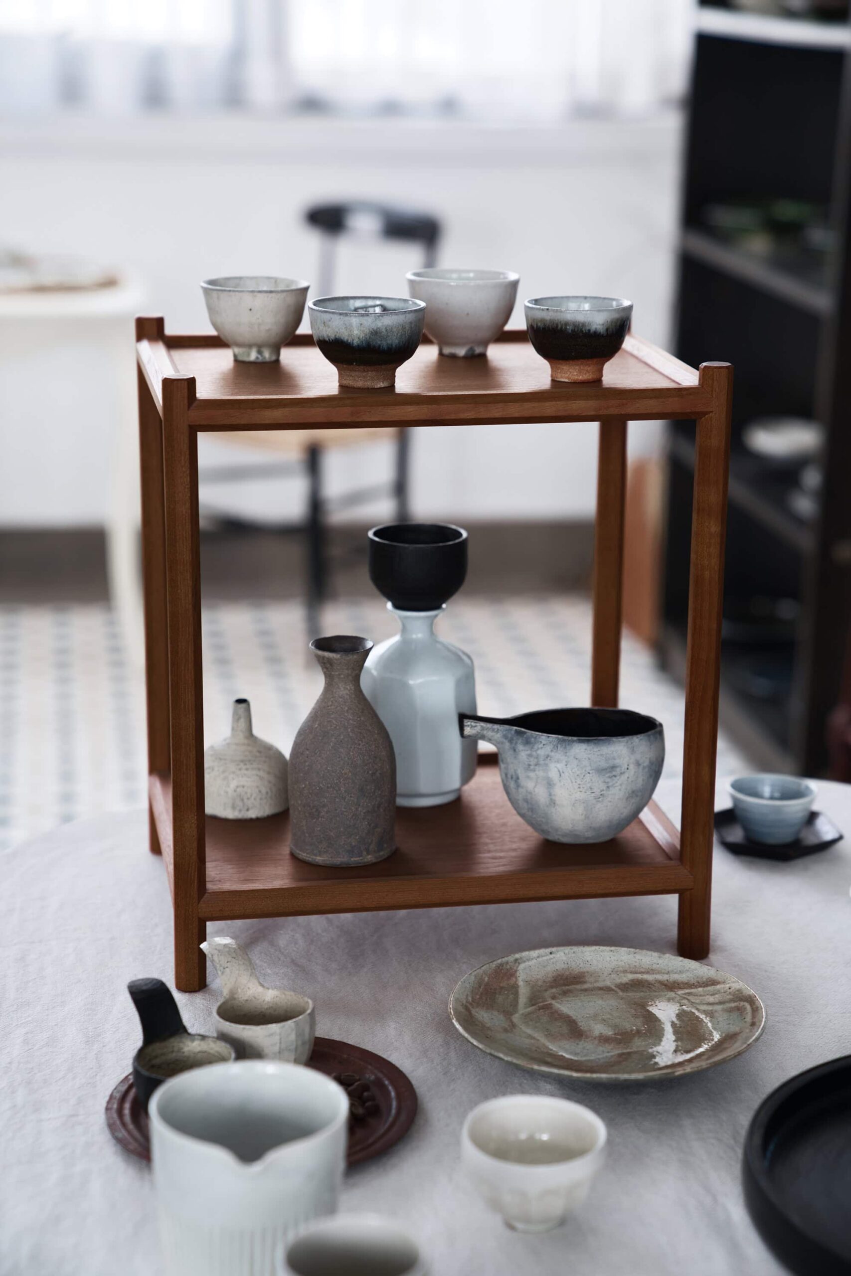Artisanal Japanese tableware collection displayed on traditional tea table with teapots and ceramic pieces at Soukai