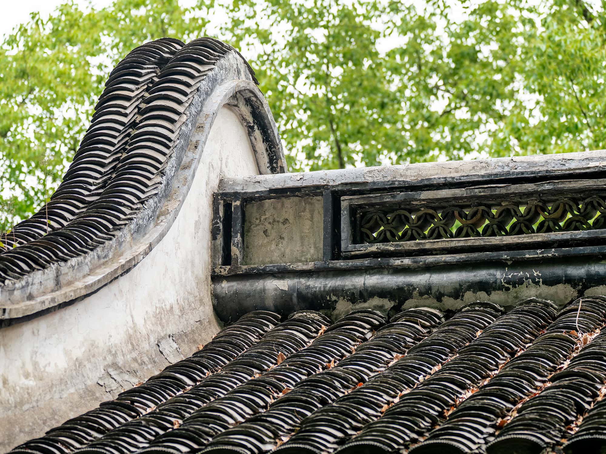 Curved ceramic roof tiles with intricate layering