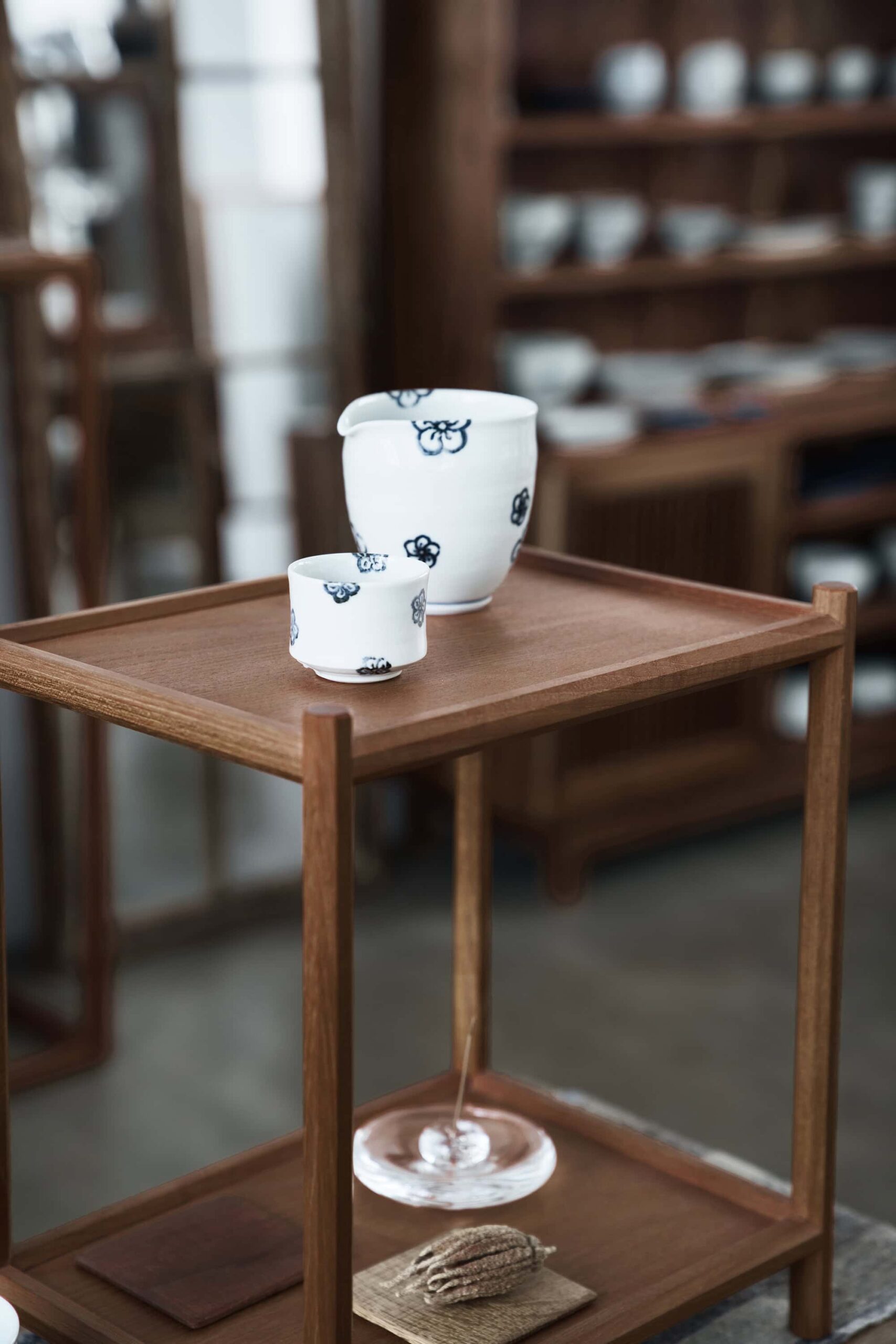Warm wooden table display at Soukai teaware store showcasing minimalist Japanese ceramic pieces in a serene setting