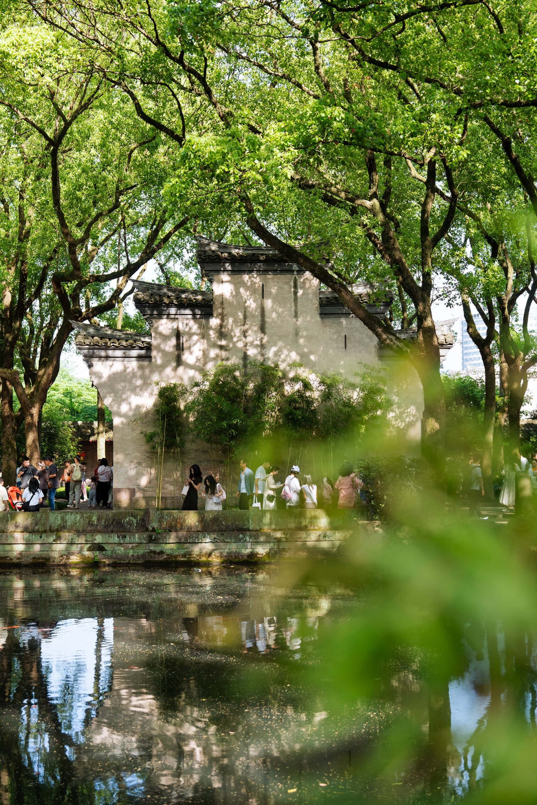 Wide view of the horse-head walls surrounded by towering tree canopies in the East Garden of the Tianyi Pavilion Library