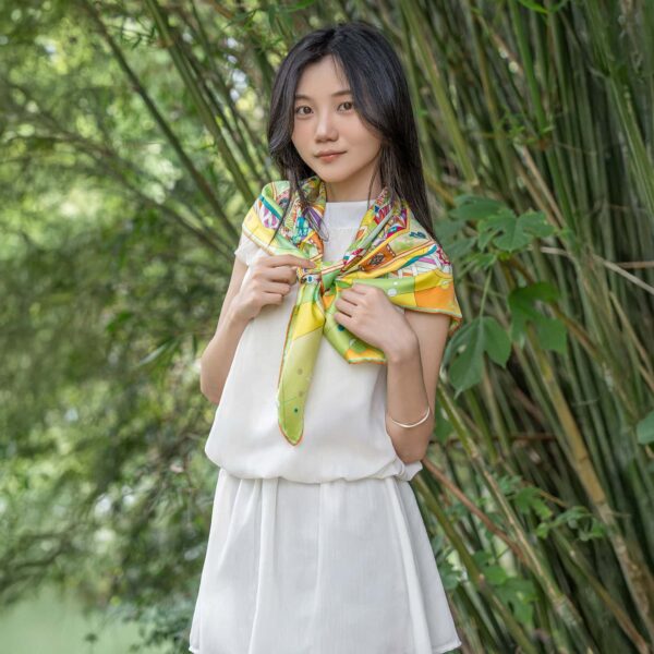 Creative styling of Wensli scarf worn as shoulder accessory with white dress