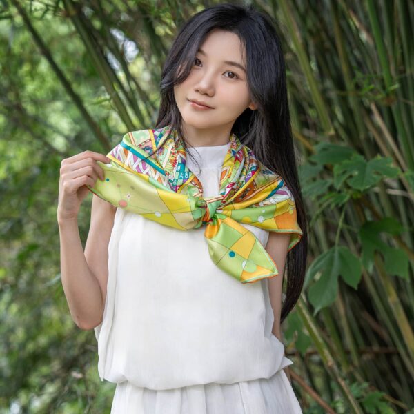 Portrait of woman in white dress wearing colorful Wensli scarf