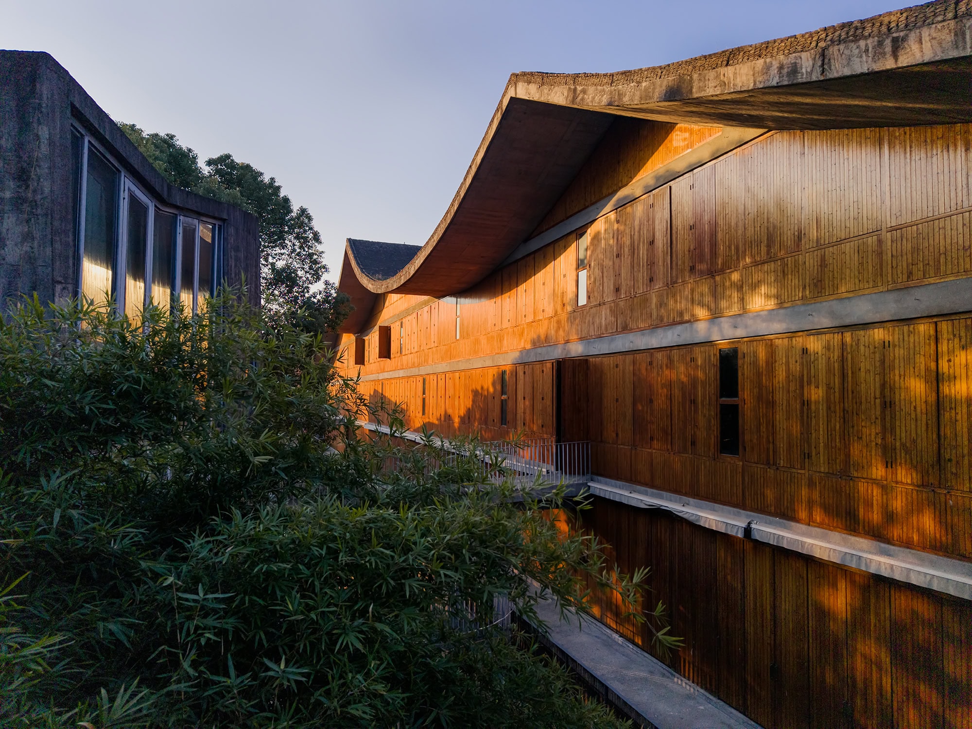 View along the façade of a wooden-clad teaching building at China Academy of Art, Xiangshan Campus in Hangzhou