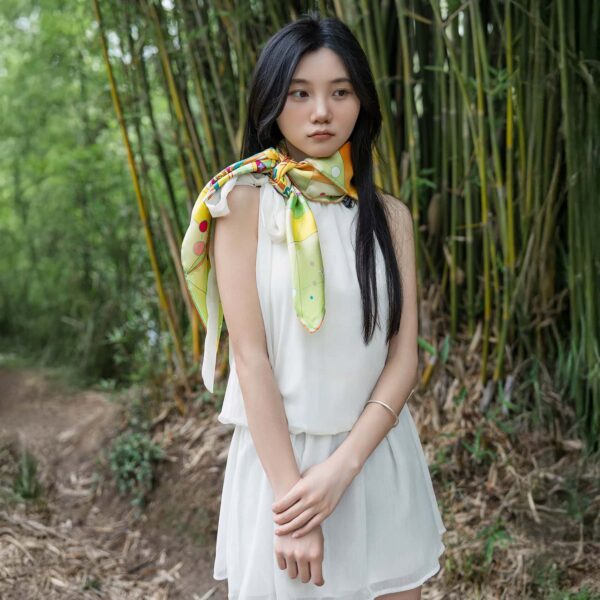 Wensli silk scarf worn elegantly around neck with white dress