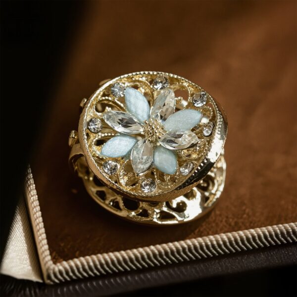 Chinese vintage hair claw clip with delicate openwork flower motif and shimmering zircon details