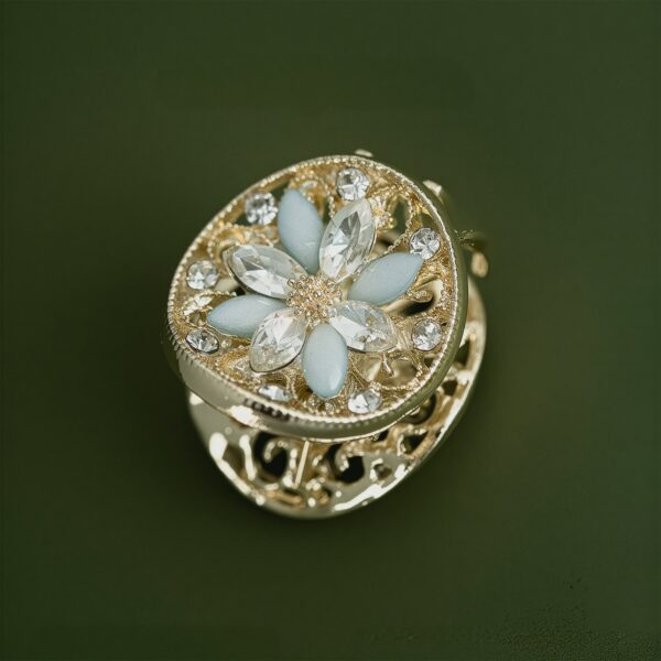Gold vintage-style hair claw clip featuring a hollow-carved four-petal flower with sparkling zircon stones