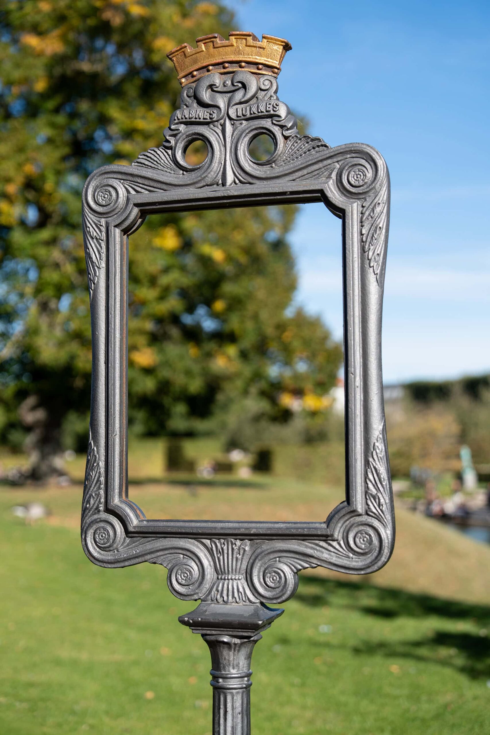 Artistic outdoor installation framing the lush greenery of a Copenhagen's Rosenborg Garden