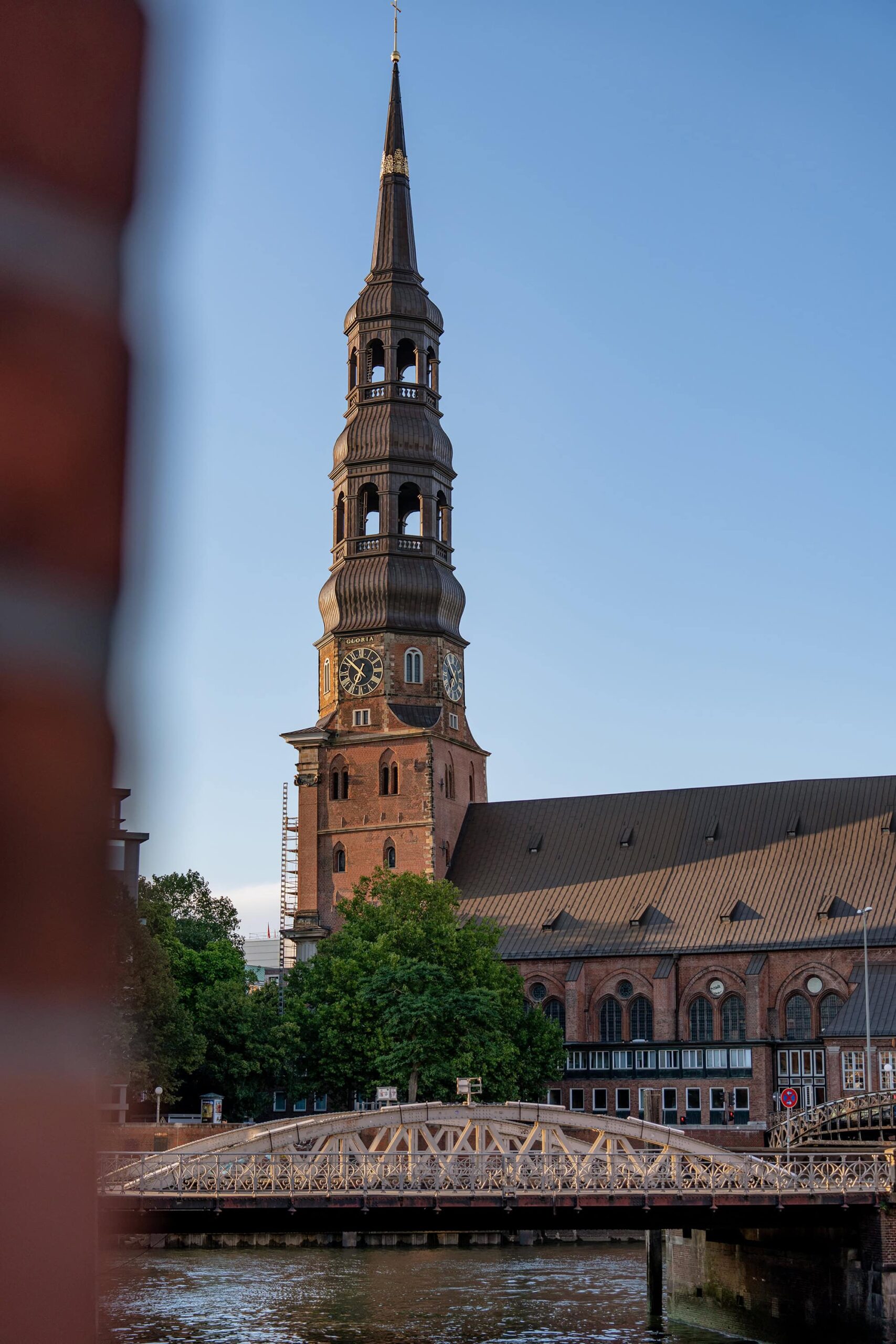 Close up of the St. Catherine’s Church tower in Hamburg, highlighting its baroque spire and red‑brick façade