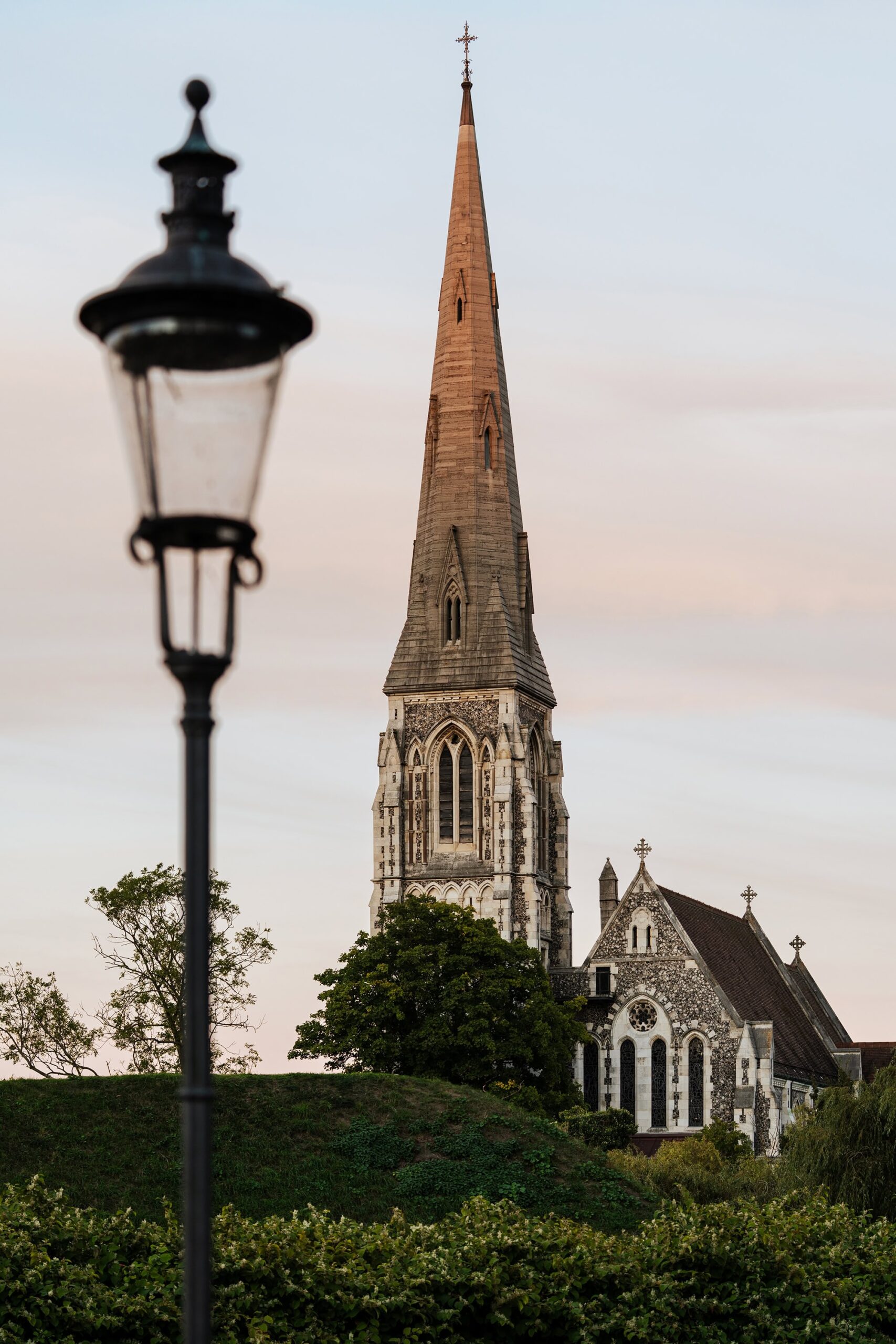 Evening view of St. Alban’s Church near Kastellet Copenhagen, showing the tall spire and old streetlamp