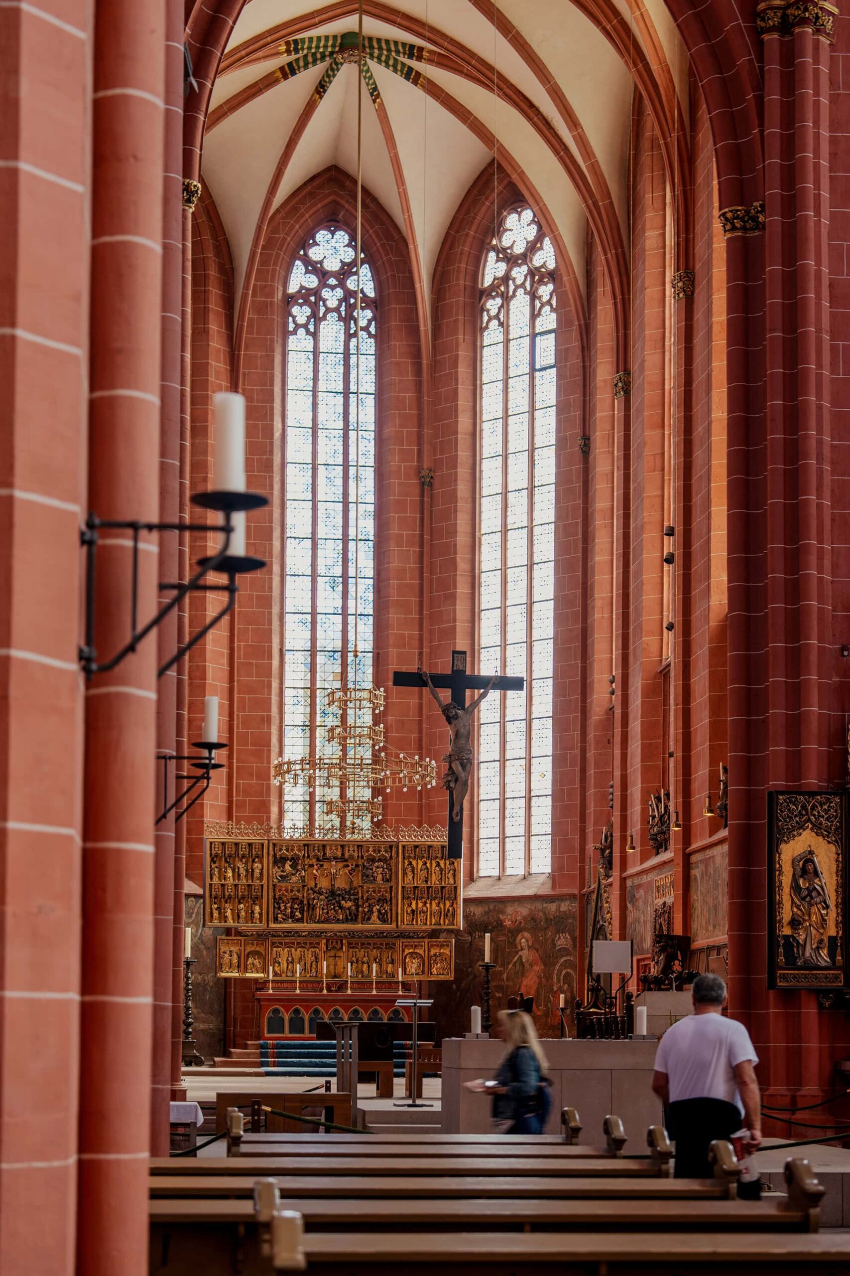 Interior of the Kaiserdom Frankfurt highlighting the grand organ, Gothic arches, and golden altar