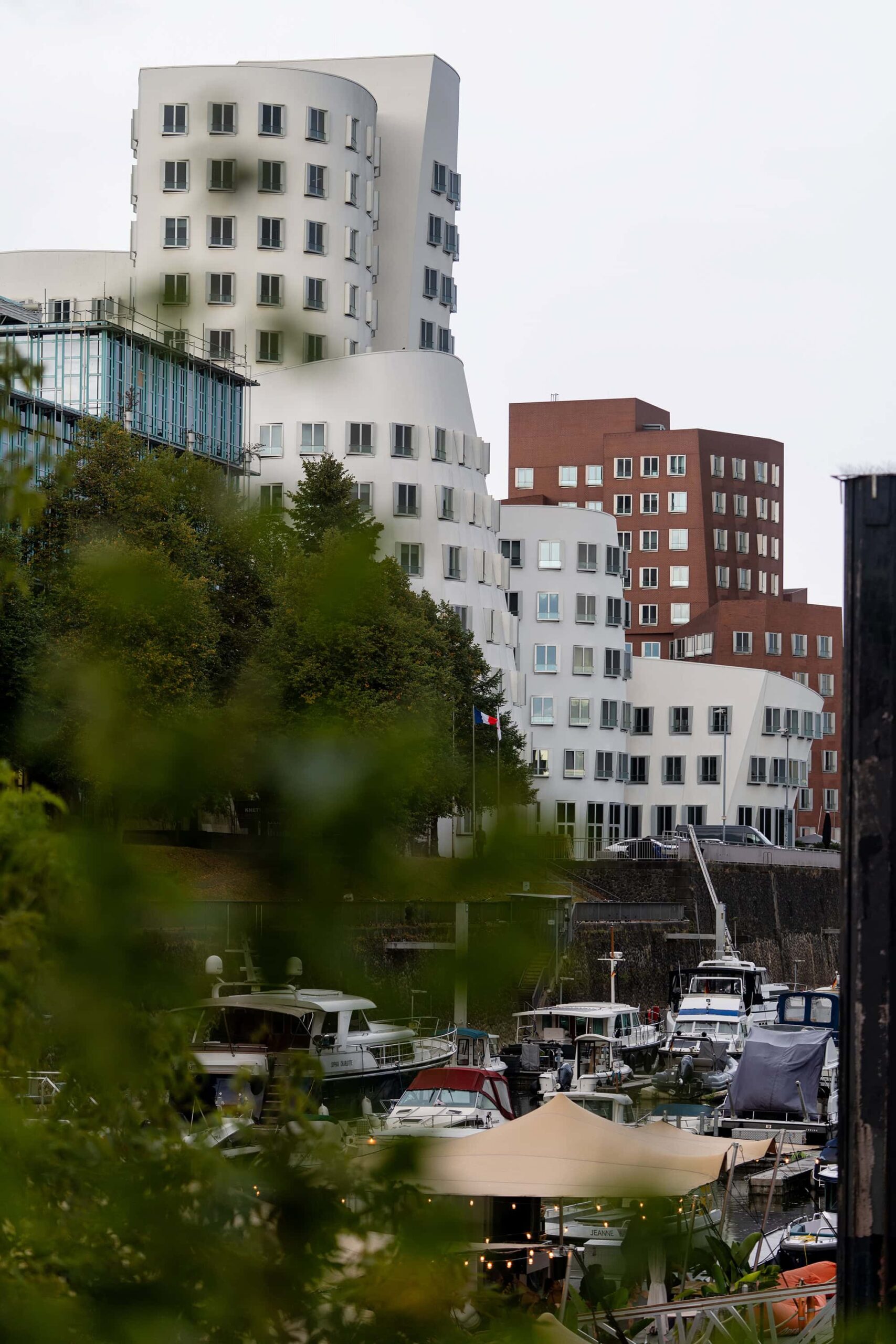 Modern architecture and waterfront view of Medienhafen Duesseldorf with boats moored along the Rhine