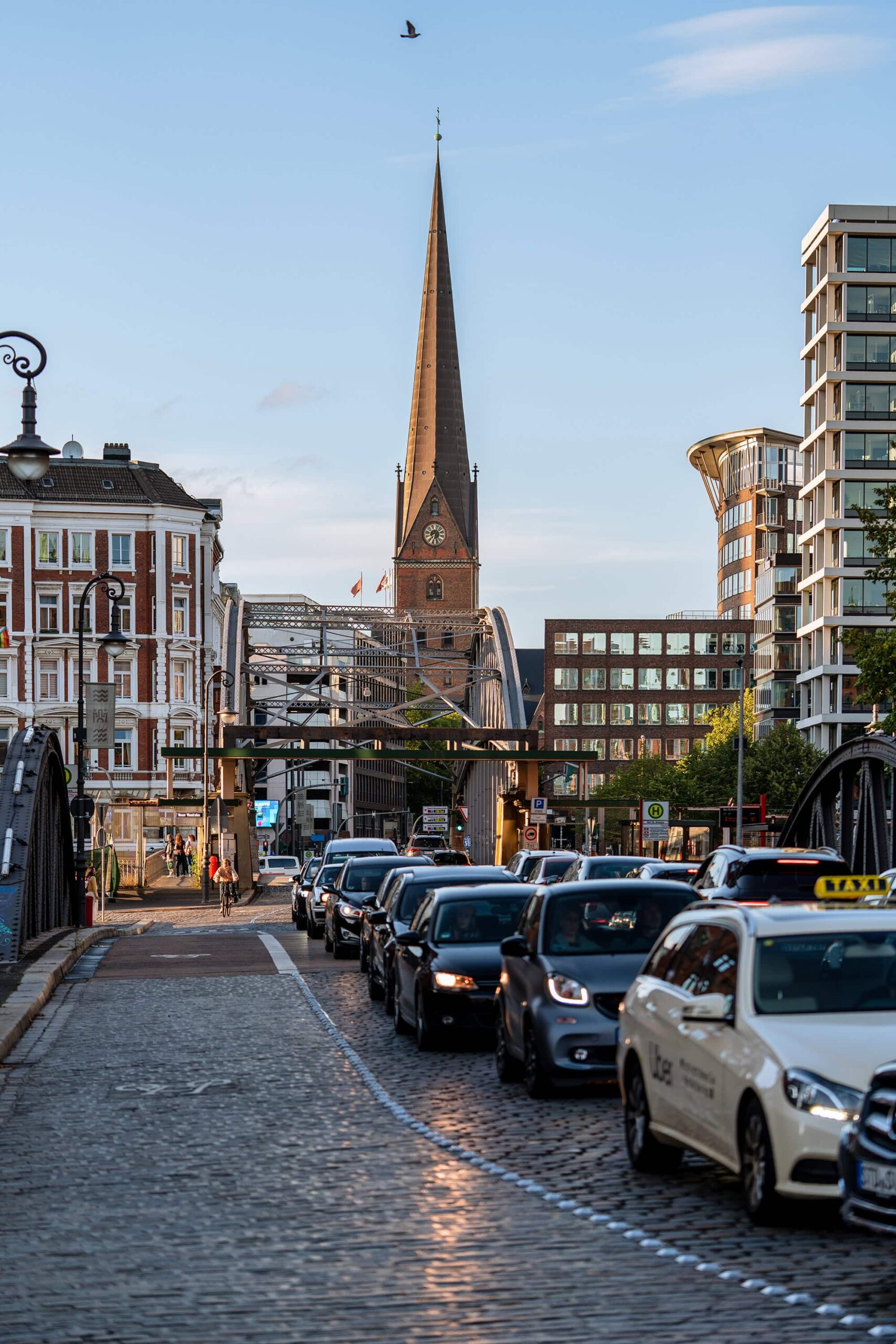 Traffic and city life in front of St Catherines Church, a historic principal church in Hamburg