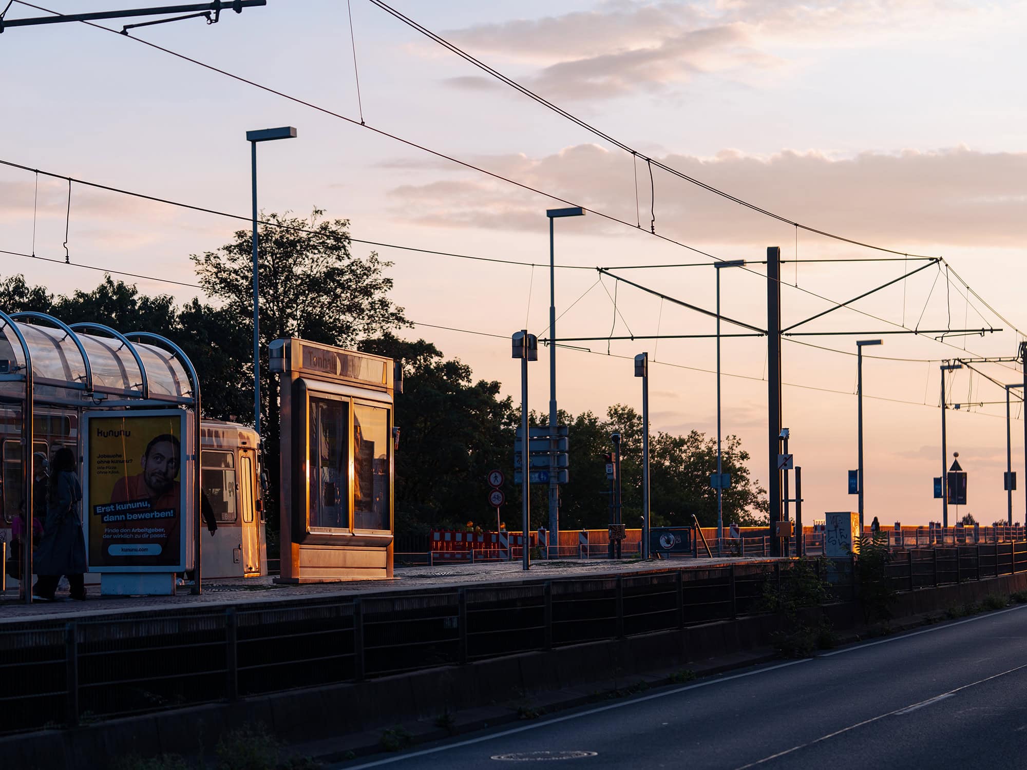 Tram station near Tonhalle Düsseldorf at sunset, with warm evening light along the Ehrenhof area