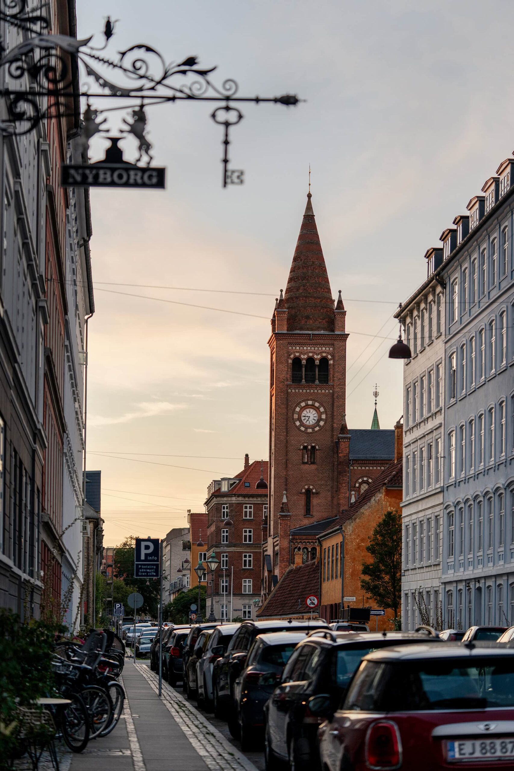 View of Copenhagen’s charming city street leading to a majestic church spire