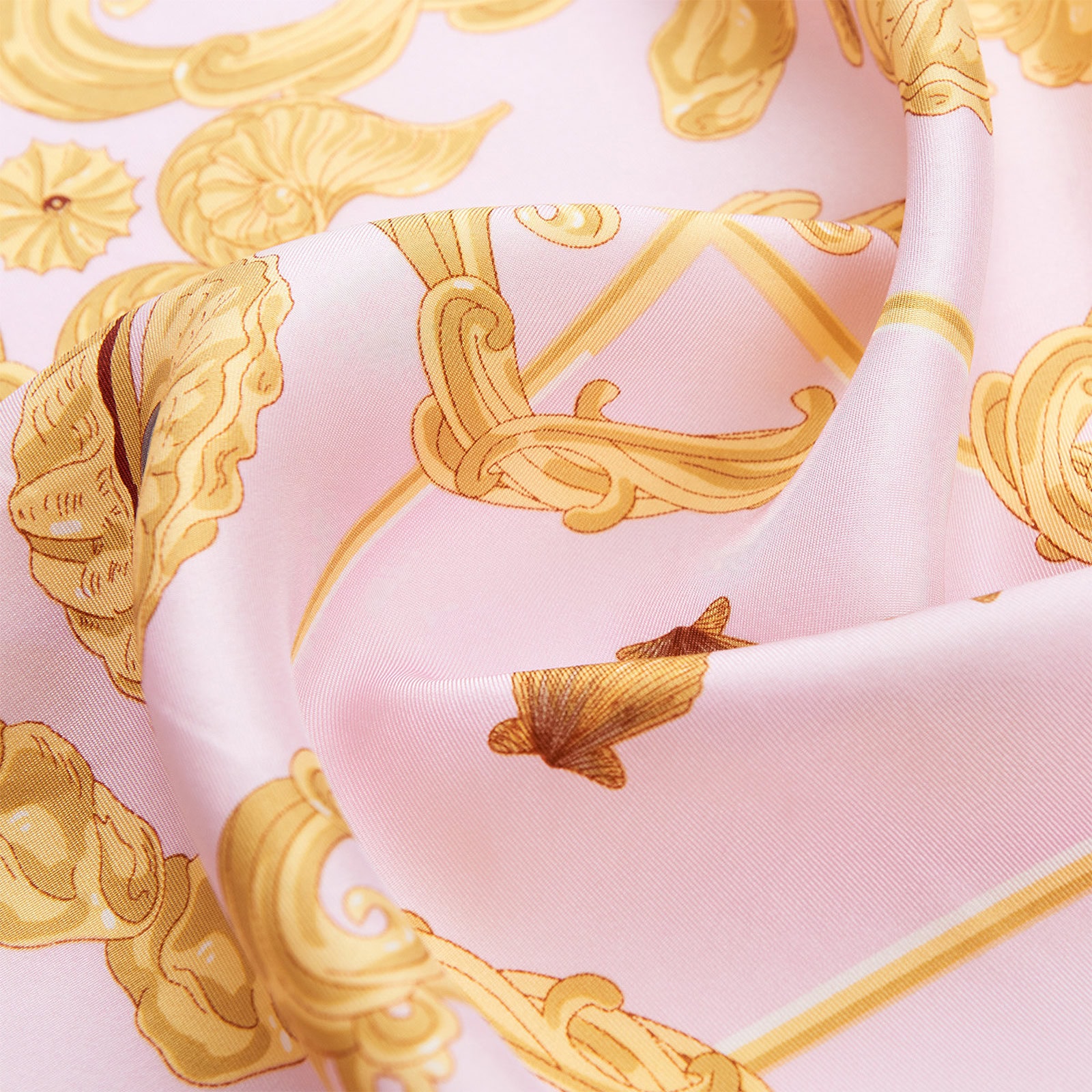 Close-up of Wensli silk scarf fabric showing delicate gold baroque detailing and soft pink sheen