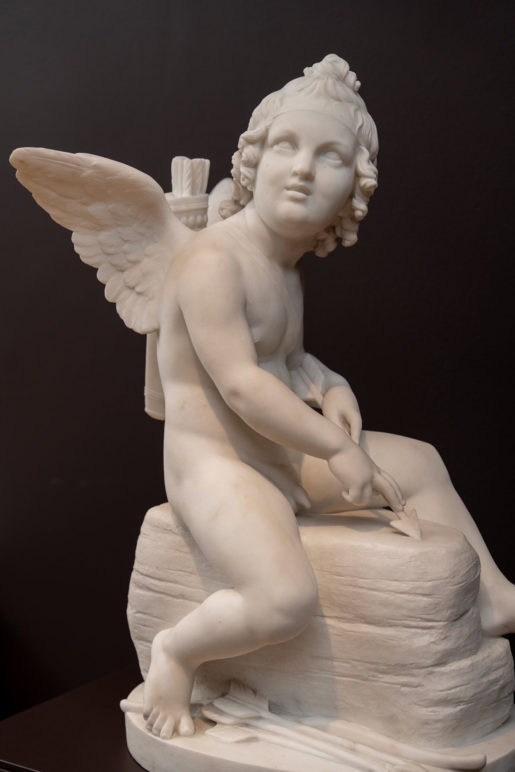 Cupid Sharpening His Arrow (Amor sliber sin pil) by Danish sculptor H.W. Bissen at the Ny Carlsberg Glyptotek collection in Copenhagen