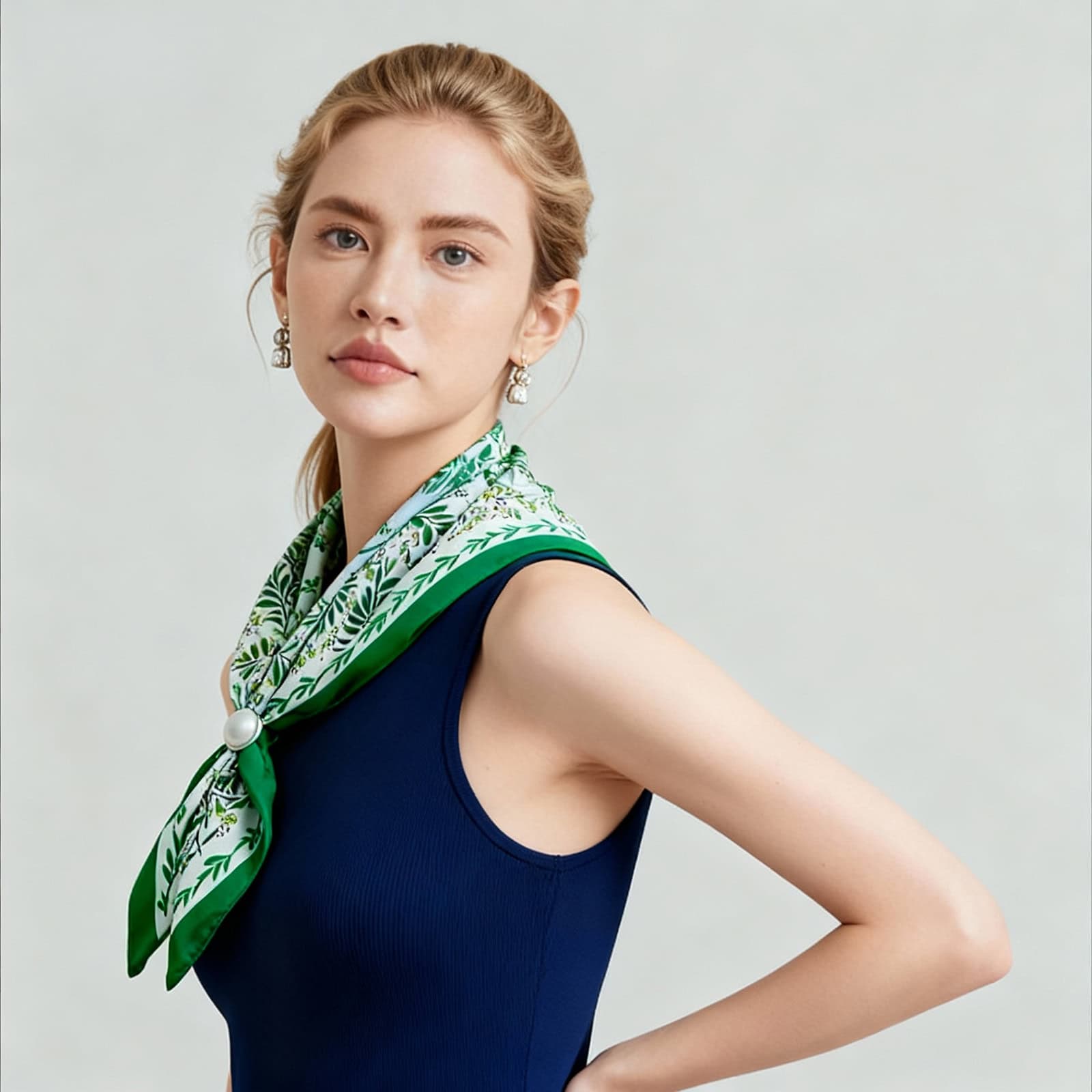 Model posing in a navy top with Shanghai Story silk scarf in green floral pattern, elegant neck styling for women