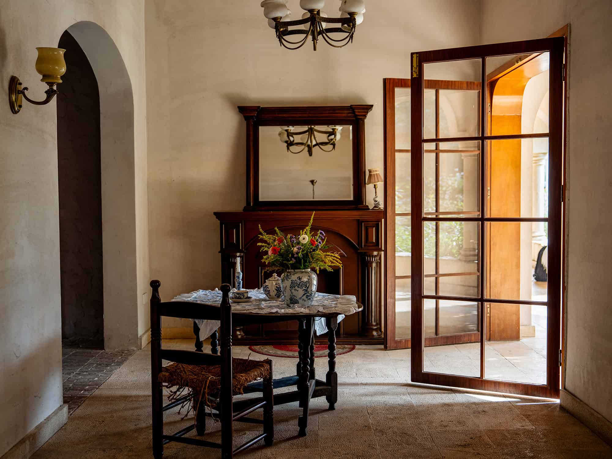 Rustic dining setup with wooden furniture and floral centerpiece at Yunxi Manor
