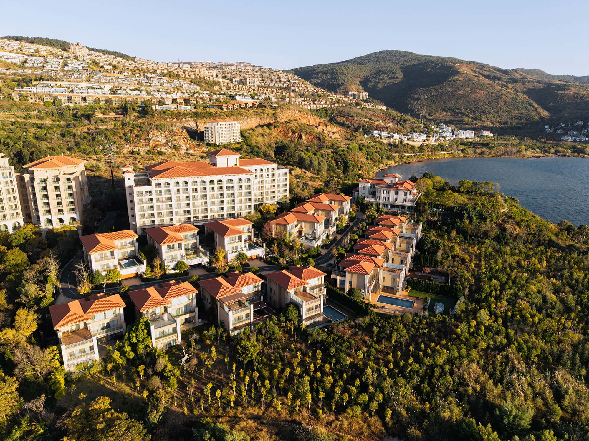 Hilton Yuxi Fuxian Lake on the hillside, overlooking the lake with distant hillside mansions and luxury villas