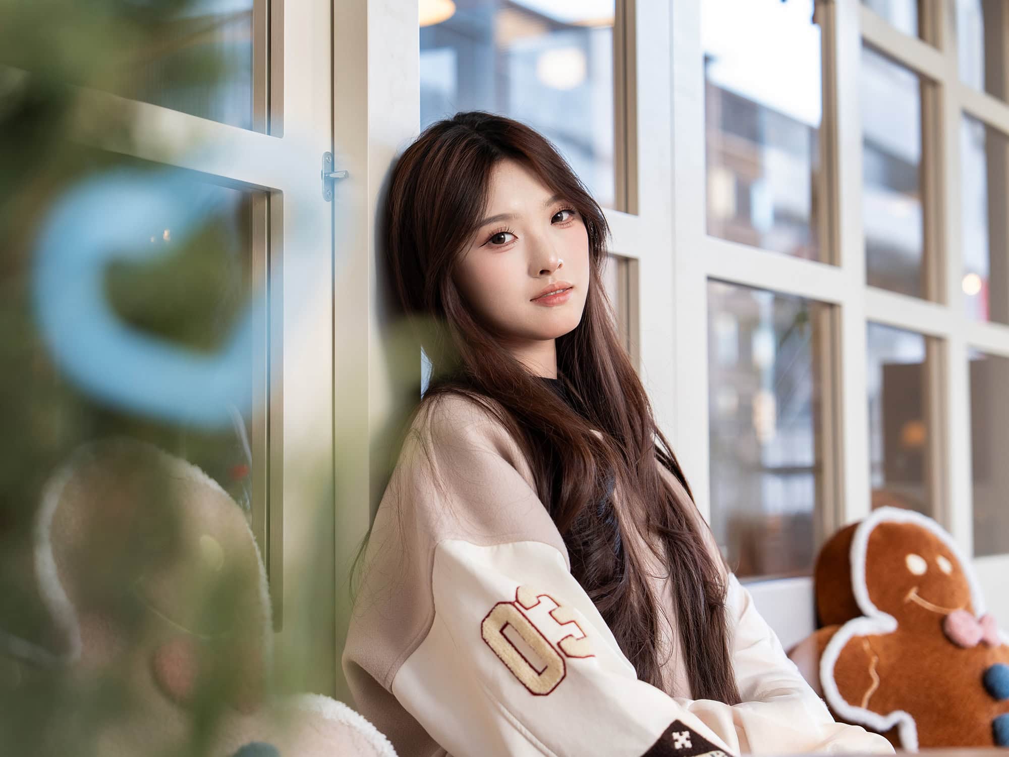Portrait of a woman sitting on a chair by the window outside DONGUDONGU Korean Family Restaurant, located on the second floor of the Brighttower Art Community (BAC) in Zhuantang