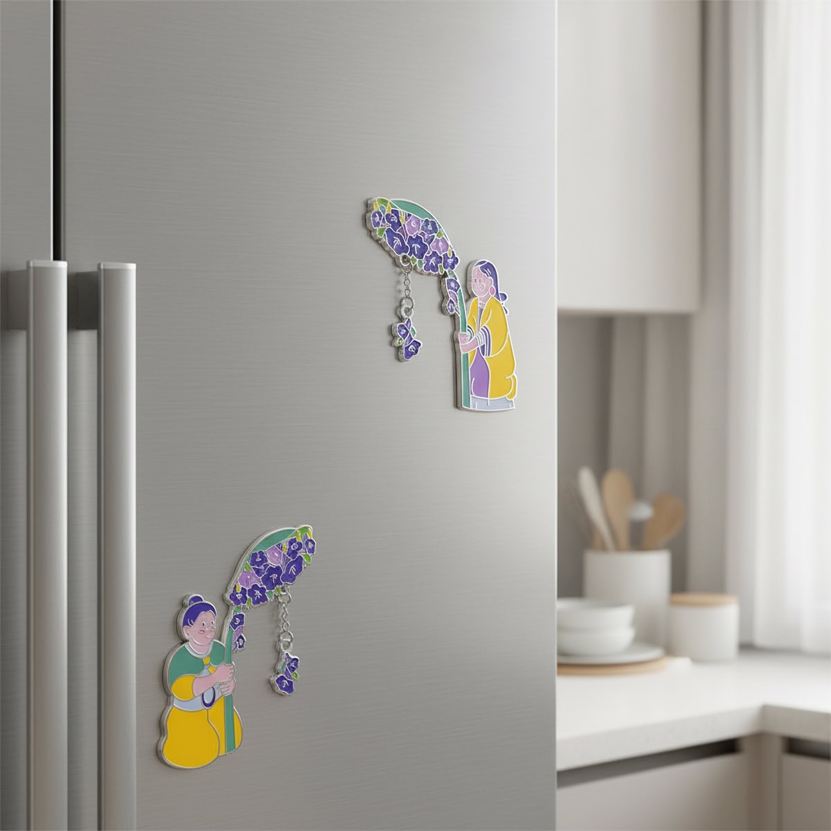 Cute magnets for fridge displayed on a stainless-steel refrigerator in a modern kitchen