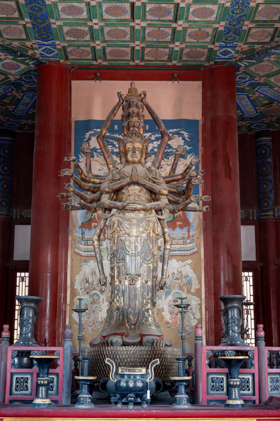 Multi-armed painted Buddhist statue in a hall at the Summer Palace in Beijing